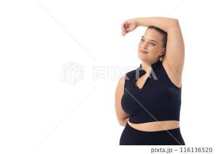 Caucasian young female plus size model on white background poses confidently, copy space Caucasian young female plus size model on white background poses confidently, copy space 116136520