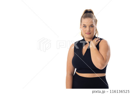 Plus size Caucasian young female model in black sportswear on white background, copy space Plus size Caucasian young female model in black sportswear on white background, copy space 116136525