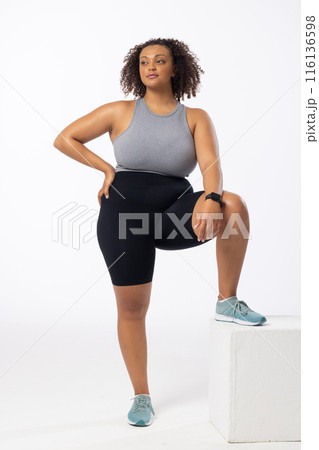 Biracial young female plus size model poses on white background 116136598