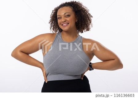 A biracial young female plus size model poses on white background 116136603