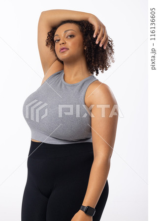 A biracial young female plus size model poses on white background 116136605