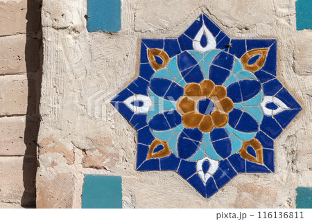 Ancient stone wall with Arabic pattern decoration, frontal view 116136811