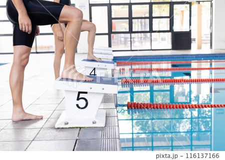 Diverse young swimmers, Caucasian boy on starting block 116137166