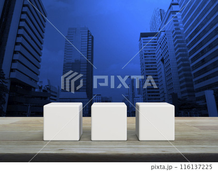 Three white block cubes on wooden table Three white block cubes on wooden table 116137225