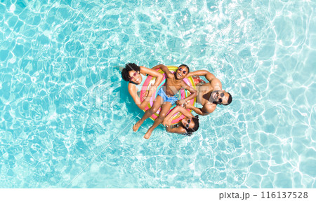 Diverse family enjoys a sunny day at the pool, with copy space Diverse family enjoys a sunny day at the pool, with copy space 116137528