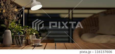A close-up image of a space on a wooden coffee tabletop on a home balcony in a nighttime. 116137606