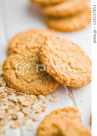 Tasty oatmeal cookies and rolled oat on white table. Tasty oatmeal cookies and rolled oat on white table. 116137651