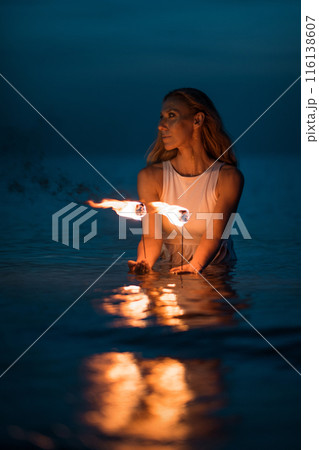 Caucasian woman dancing with fire in the water. Fire show at sea. Acrobatics on the beach. Yoga and relaxation at sunset. Spectacular circus performance. model body. High quality FullHD footage. Caucasian woman dancing with fire in the water. Fire show at sea. Acrobatics on the beach. Yoga and relaxation at sunset. Spectacular circus performance. model body. High quality FullHD footage. 116138607