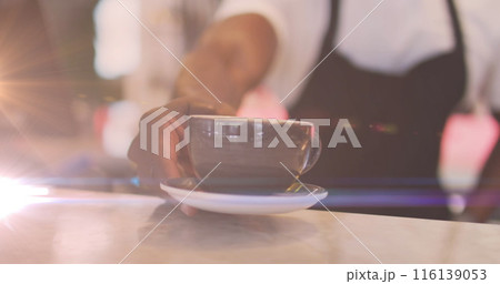Image of glowing light over african american male barista serving coffee Image of glowing light over african american male barista serving coffee 116139053