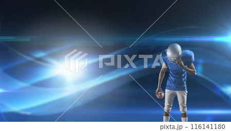Image of excited american football player holding ball on dark background with moving lights Image of excited american football player holding ball on dark background with moving lights 116141180