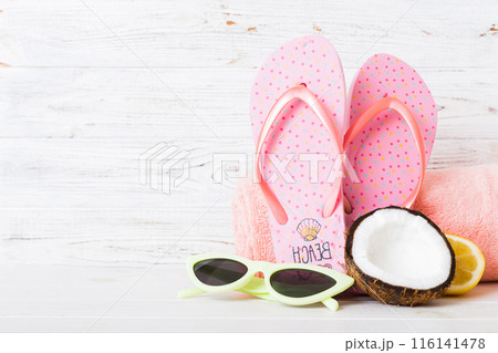 Top view composition of flip flops placed with beach accessories perspective view on table background. Tropical summer vacation concept Flat lay 116141478