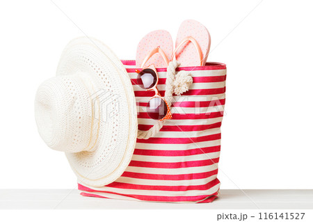 Stylish bag with beach accessories . Summer holiday concept. beach bag with straw hat with space for text Stylish bag with beach accessories . Summer holiday concept. beach bag with straw hat with space for text 116141527