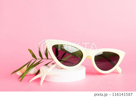sunglasses with seashell lying on table background. Sunglasses on summer background. Top view flat lay with copy space for text sunglasses with seashell lying on table background. Sunglasses on summer background. Top view flat lay with copy space for text 116141587