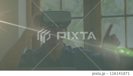 Caucasian male chef wearing virtual reality headset, pointing 116141871