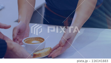 Person handing over coffee and cake to another, both standing at table 116141883