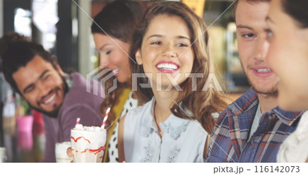 Group of diverse friends enjoying time together, holding drinks Group of diverse friends enjoying time together, holding drinks 116142073