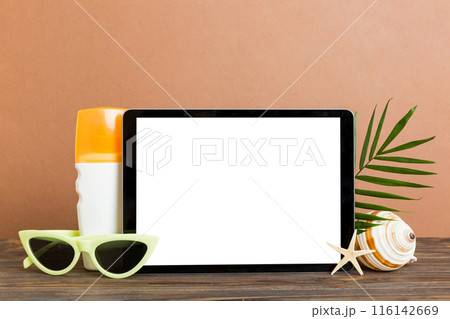 Flat lay composition with tablet and beach accessories on colored background. Tablet computer with blank screen mock up with copy space 116142669