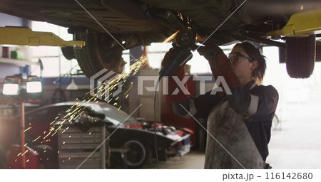 Image of light trails over caucasian female mechanic at workshop Image of light trails over caucasian female mechanic at workshop 116142680