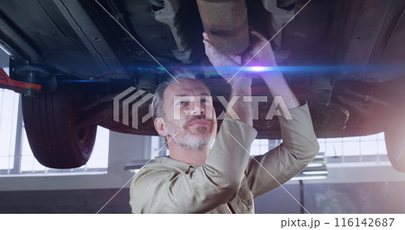 Image of light trails over caucasian male mechanic reapiring car 116142687