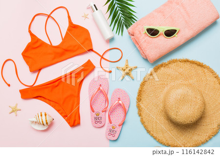 Woman swimwear and beach accessories flat lay top view. Top view with bikini outfit on color background. Vacation concept copy space 116142842