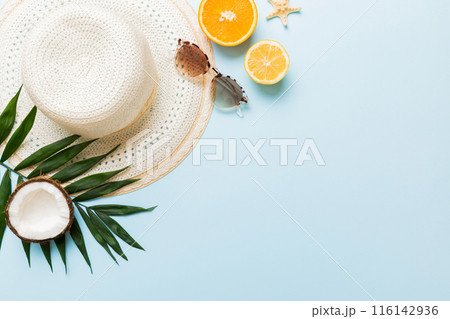 Top view of various seashells placed near colorful fruit and stylish summer accessories on table background. Summer concept. Flat lay. Top view with copy space for text Top view of various seashells placed near colorful fruit and stylish summer accessories on table background. Summer concept. Flat lay. Top view with copy space for text 116142936