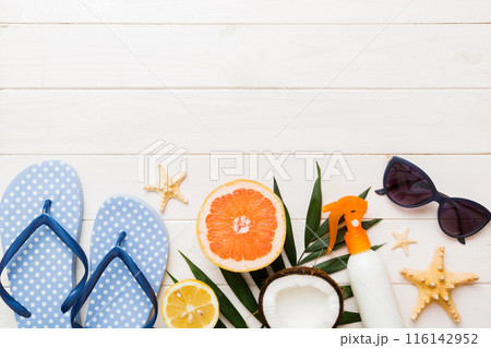 Top view composition of flip flops placed with beach accessories top view on table background. Tropical summer vacation concept Flat lay 116142952