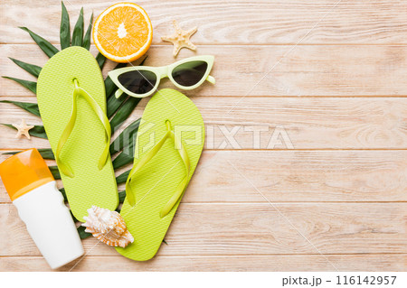 Top view composition of flip flops placed with beach accessories top view on table background. Tropical summer vacation concept Flat lay 116142957