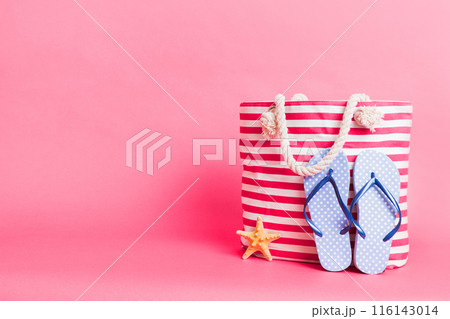 Stylish bag with beach accessories . Summer holiday concept. beach bag with straw hat with space for text 116143014