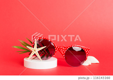 sunglasses with seashell lying on table background. Sunglasses on summer background. Top view flat lay with copy space for text 116143160