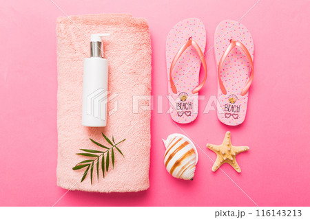 Summer holiday concept. Top view of beach towel, flip flop and sunscreen cream on table Top view with copy space for text 116143213
