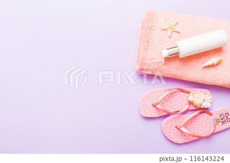 Summer holiday concept. Top view of beach towel, flip flop and sunscreen cream on table Top view with copy space for text 116143224