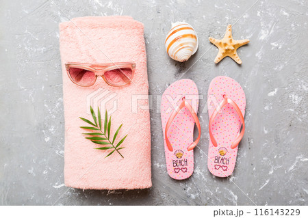 Summer sunbathing beach background, sunglasses, flip flops and towel, Top view with copy space for text 116143229