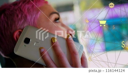 Image of connected icons globe over biracial woman talking on cellphone while sitting in car 116144124