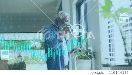 Image of graphs, icons, senior african american man scrolling on cellphone while drinking coffee 116144125