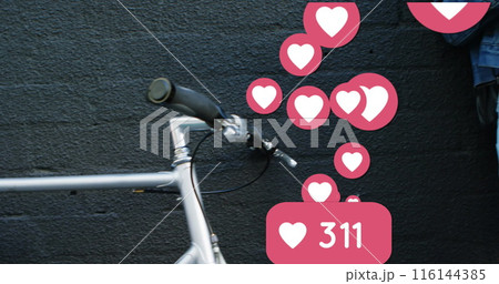 Image of social media heart icons over woman using smartphone and drinking coffee 116144385