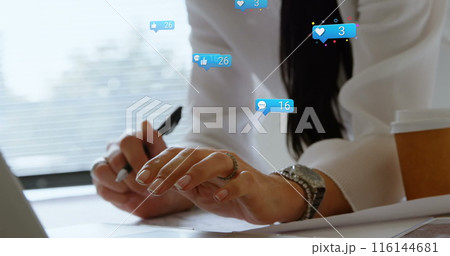 A Caucasian middle-aged woman wearing white blouse is writing 116144681