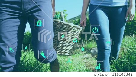 Caucasian couple holding hands, walking in field Caucasian couple holding hands, walking in field 116145342