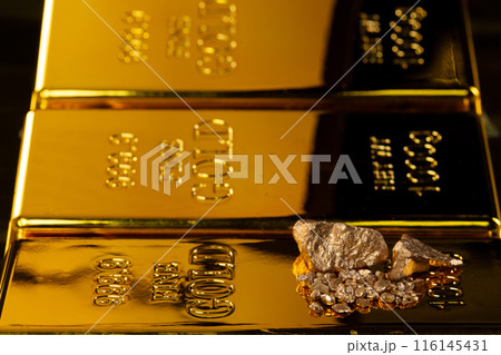 Gold Bar arrange and reflect light with element, nugget, ingot. Gold bar standard is bank reserve to finance economic wealth and risk management. Black background isolated Gold Bar arrange and reflect light with element, nugget, ingot. Gold bar standard is bank reserve to finance economic wealth and risk management. Black background isolated 116145431