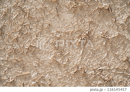 texture of old traditional Asian clay wall with straw close-up 116145457