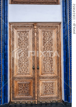 Wooden carved door with oriental pattern Uzbek islamic ornament in Museum of Victims of Political Repression in Tashkent in Uzbekistan 116145652
