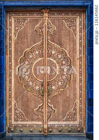 ancient carved wooden door with arabic pattern Uzbek ornament in Museum of Victims of Political Repression in Tashkent 116145662