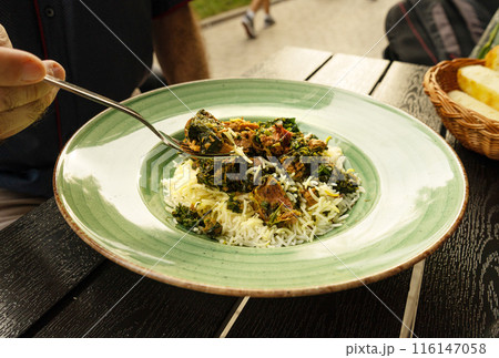 Pilau on Green Plate, Beef Pilaf, Traditional Asian Dish Plov also known as Polow, Pilav, Pallao, Pulao, Palaw 116147058