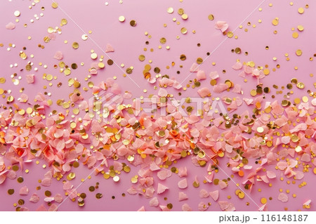 Delicate pink hues provide the perfect stage for a shower of golden confetti, bringing sparkle and cheer to the scene, infusing it with warmth and excitement 116148187