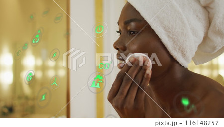 Image of icons over african american woman cleansing face in bathroom 116148257