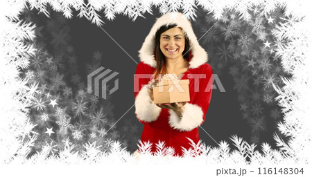 Caucasian sister in red Santa outfit holding gift box, smiling Caucasian sister in red Santa outfit holding gift box, smiling 116148304