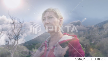 Caucasian fitness instructor, middle-aged, standing outdoors, looking thoughtful 116148352