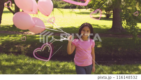 Image of pink hearts over smiling girl holding pink balloons in sunny park Image of pink hearts over smiling girl holding pink balloons in sunny park 116148532