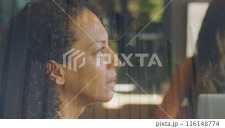 Image of financial graphs over biracial businesswoman working in office Image of financial graphs over biracial businesswoman working in office 116148774