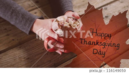 Image of happy thanksgiving day text over hands holding cocoa 116149050