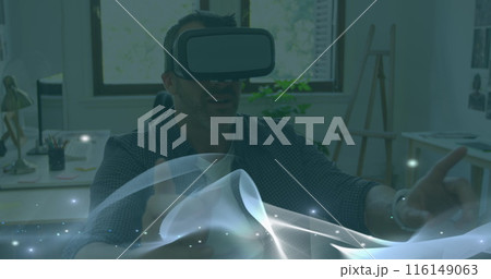 Image of light trails and spots over caucasian man using vr headset 116149063
